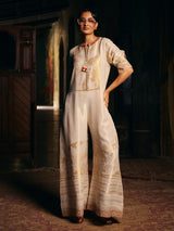 Cream womens designer silk jumpsuit with embroidered neckline