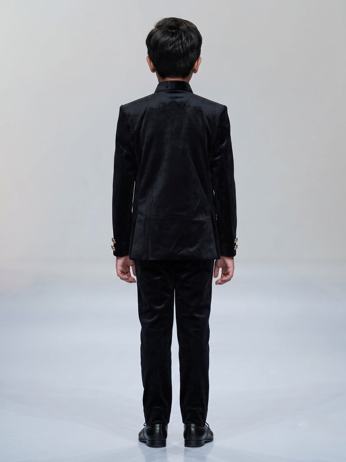 Black velvet boys jodhpuri suit with regal crest detailing