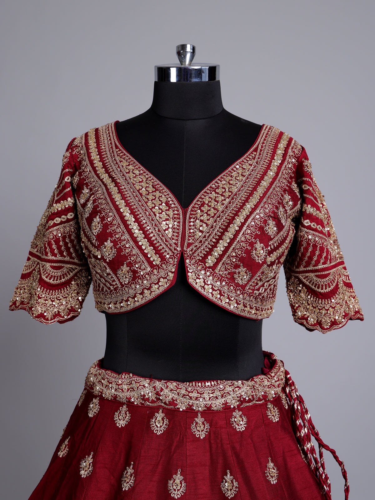 Maroon silk bridal lehenga choli with elegant zardosi embellishments