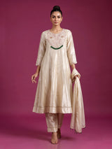 Cream silk anarkali suit with dupatta and ornate embellishments