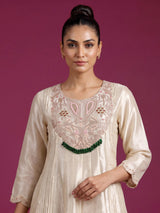 Cream silk anarkali suit with dupatta and ornate embellishments