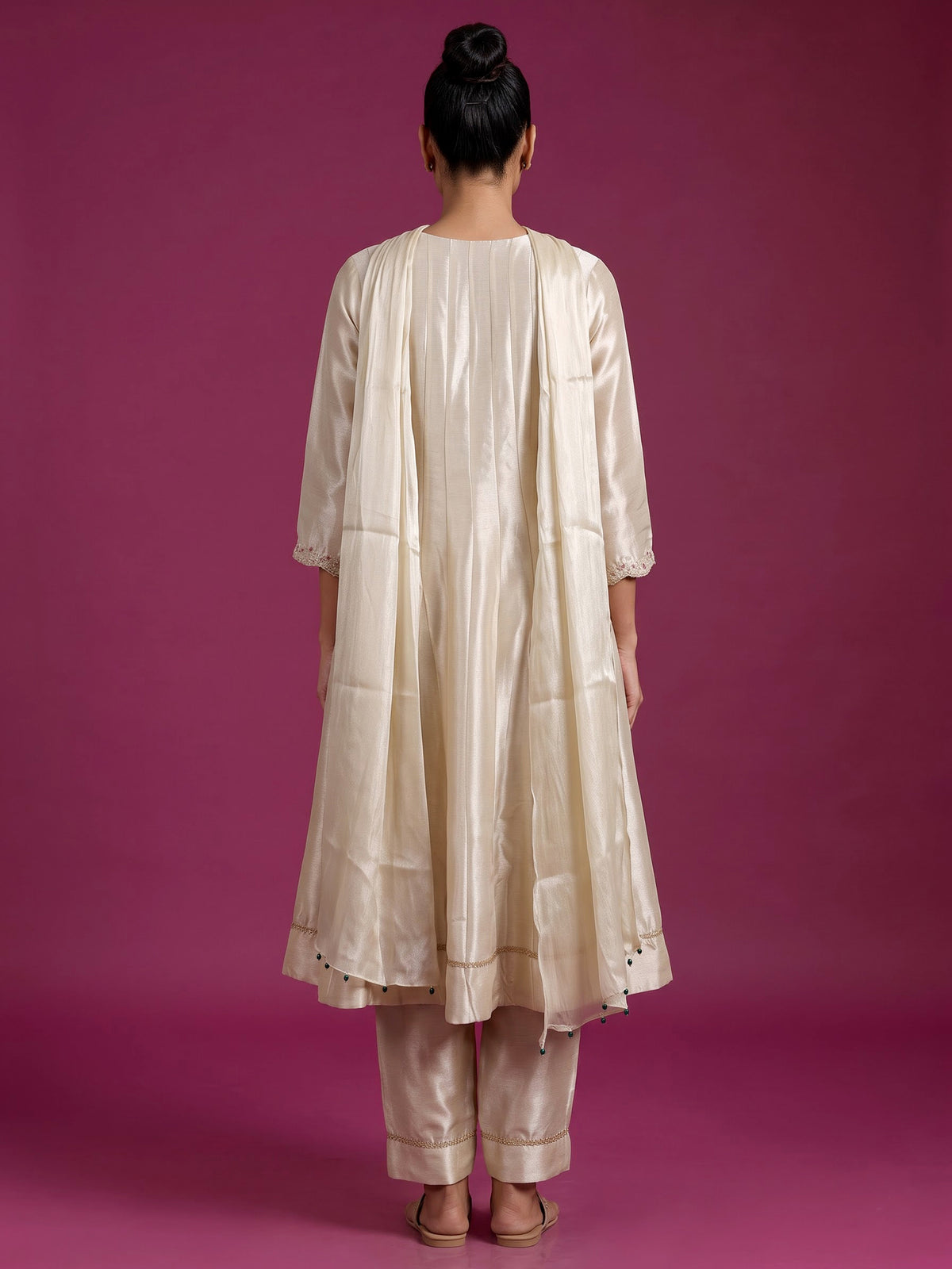 Cream silk anarkali suit with dupatta and ornate embellishments