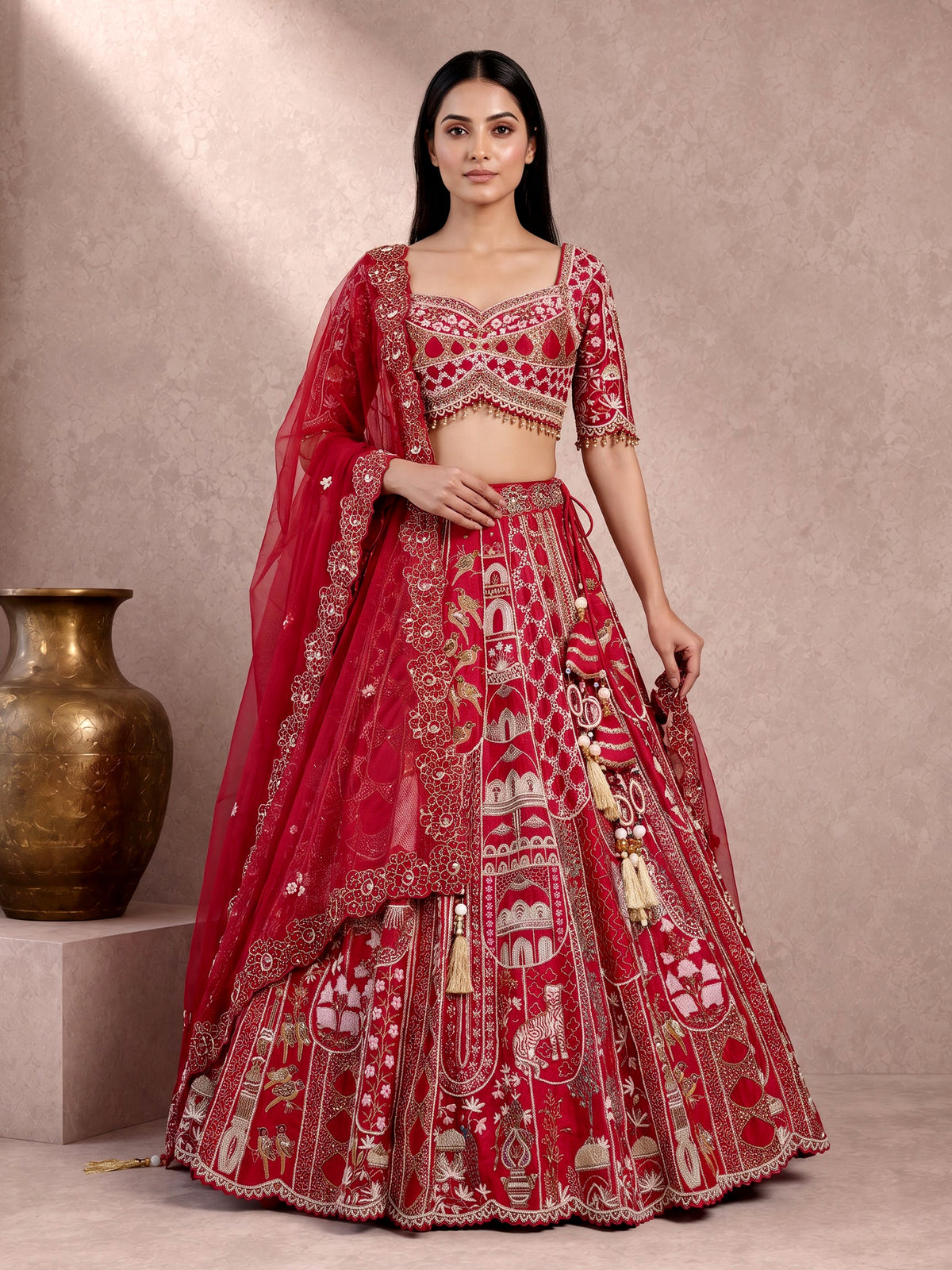 Maroon raw silk lehenga choli with artistic motifs and tassels