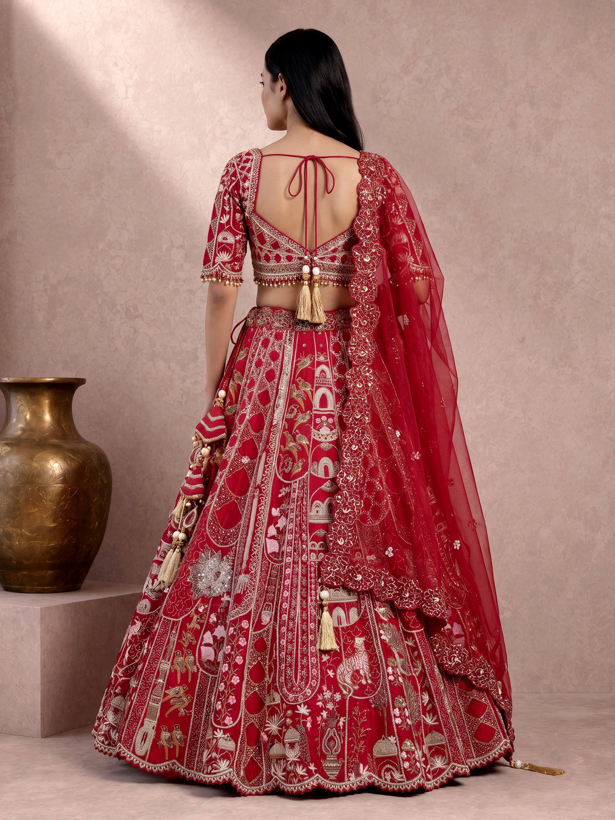 Maroon raw silk lehenga choli with artistic motifs and tassels