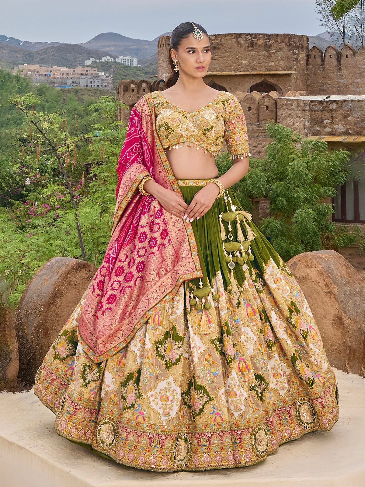 Mehendi green silk lehenga choli with colorful motifs and contrast dupatta