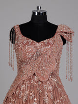 Dusty peach ball gown with floral embellishments and fringe