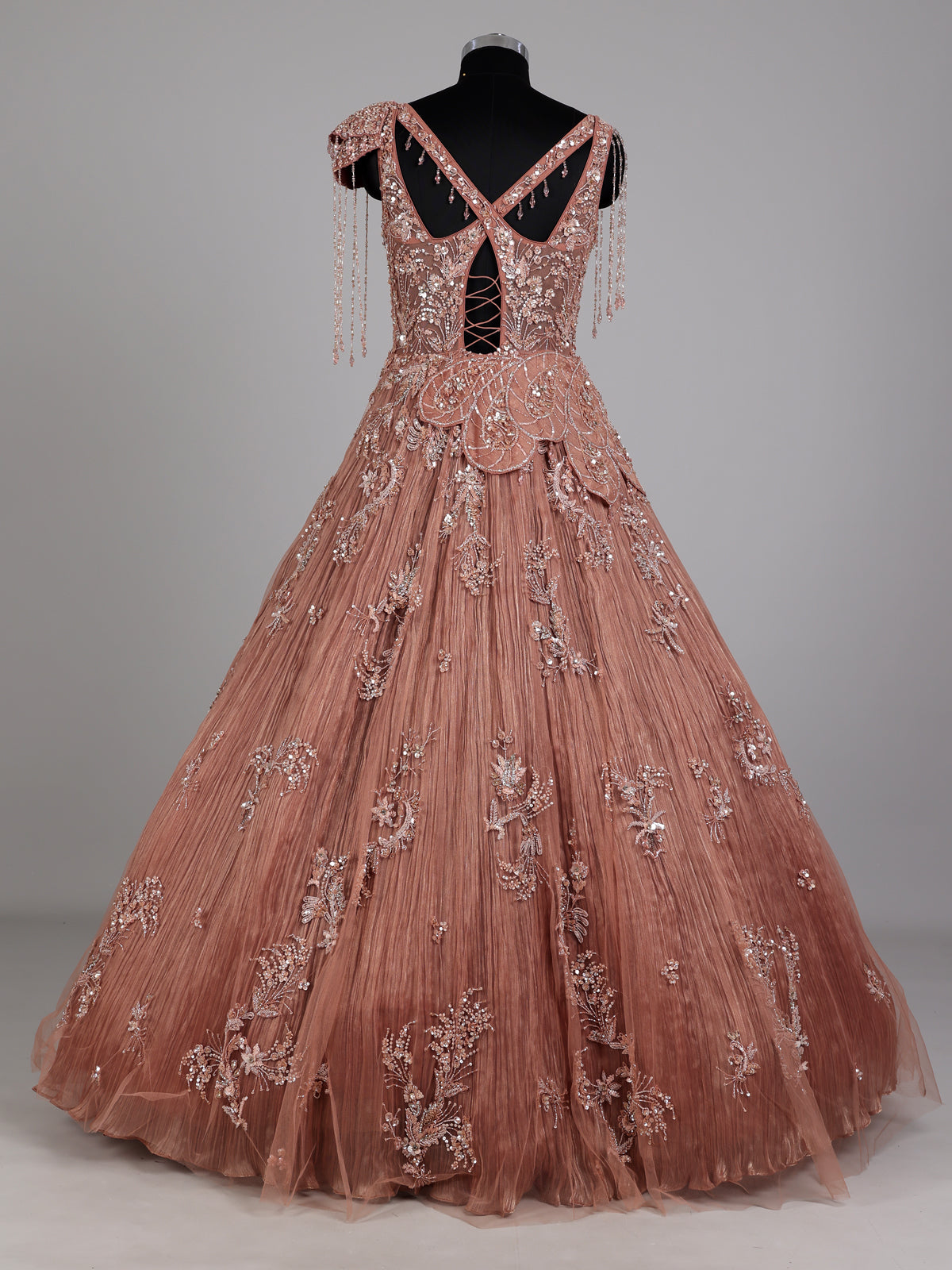 Dusty peach ball gown with floral embellishments and fringe
