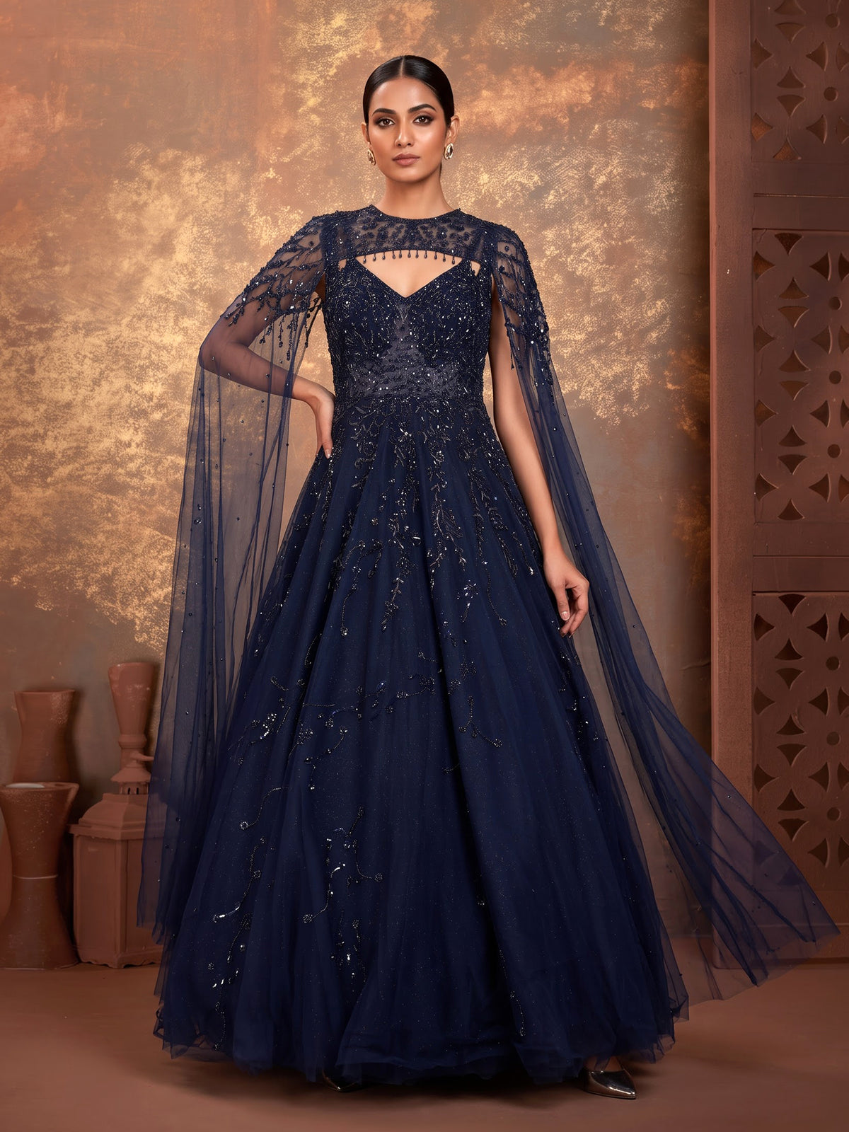 Midnight navy ball gown with embellished cape and flared skirt