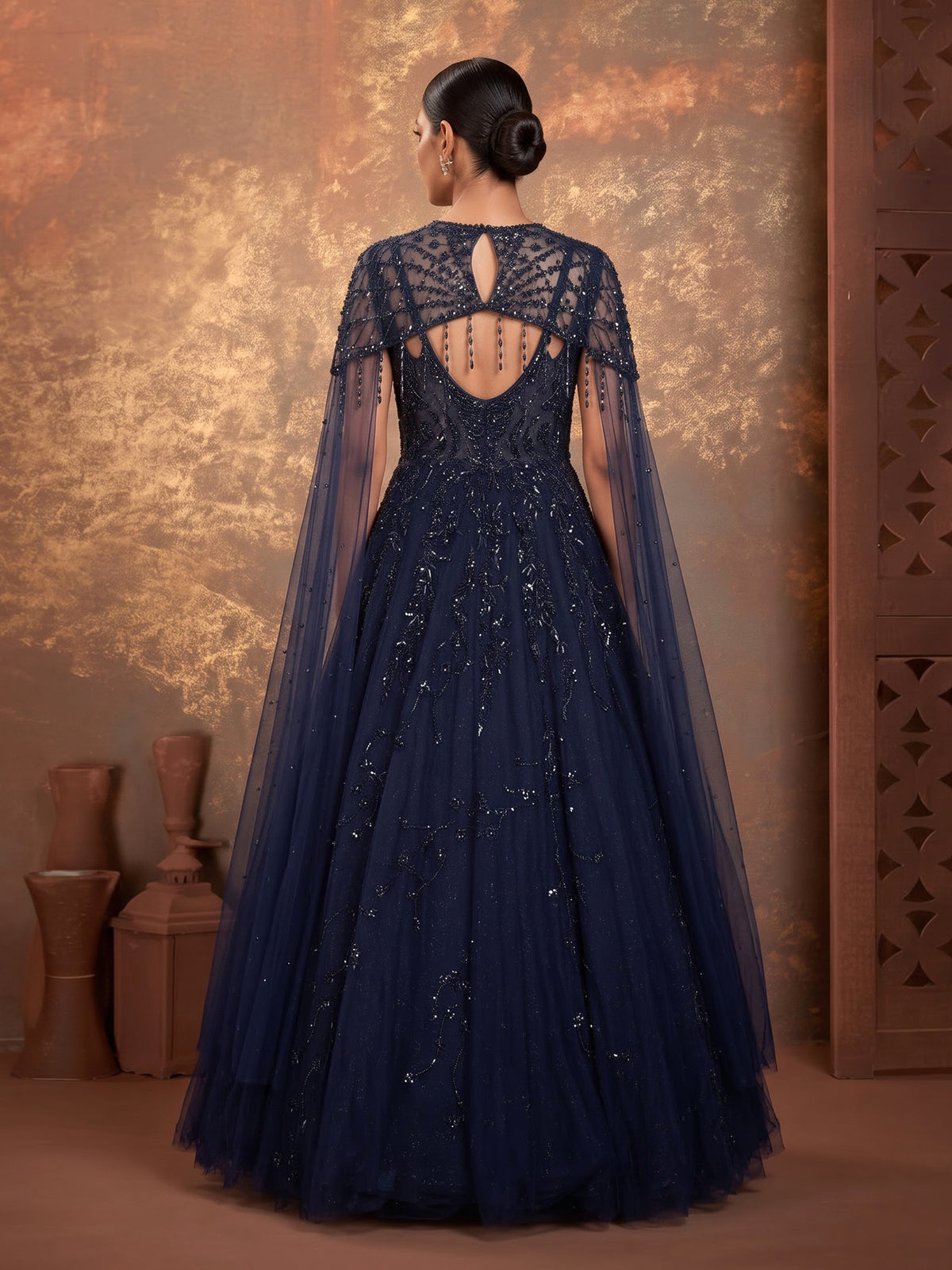 Midnight navy ball gown with embellished cape and flared skirt
