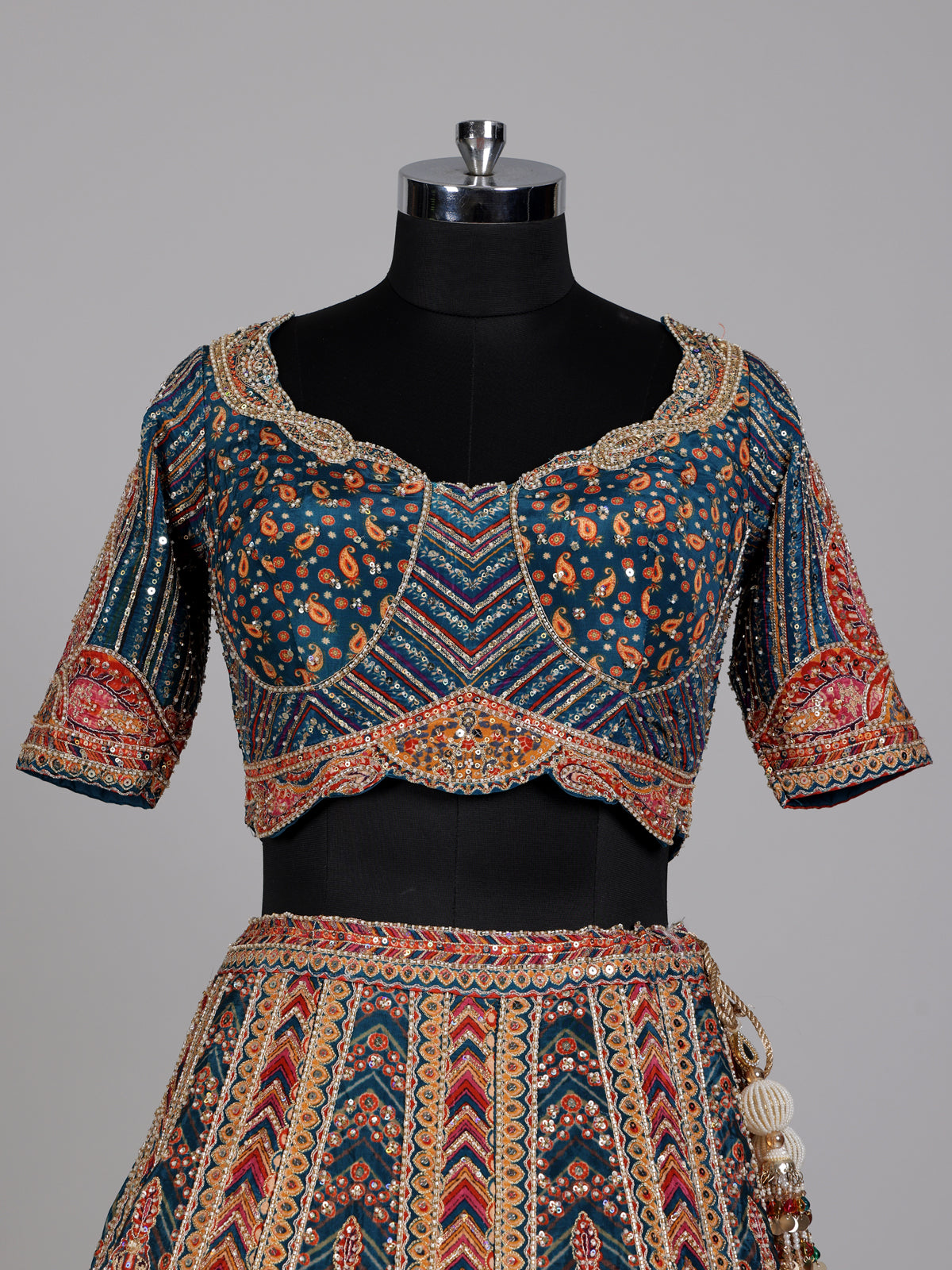 Teal blue lehenga choli with rust paisley detailing