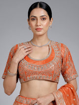 Rust orange banarasi silk lehenga choli with embellished dupatta
