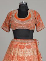 Rust orange banarasi silk lehenga choli with embellished dupatta