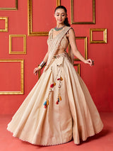 Beige silk designer wedding lehenga choli with tassel accents dupatta
