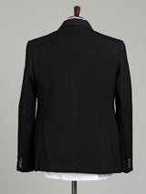 Jet black three-piece tuxedo suit with crystal brooch and cutdana