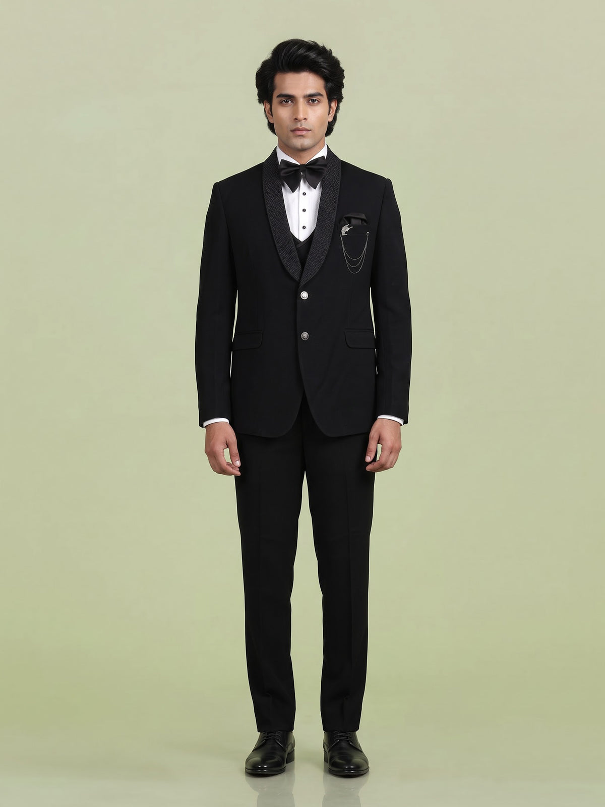 Jet black three-piece tuxedo suit with crystal brooch and cutdana
