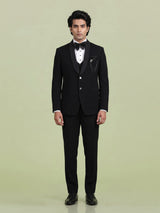Jet black three-piece tuxedo suit with crystal brooch and cutdana