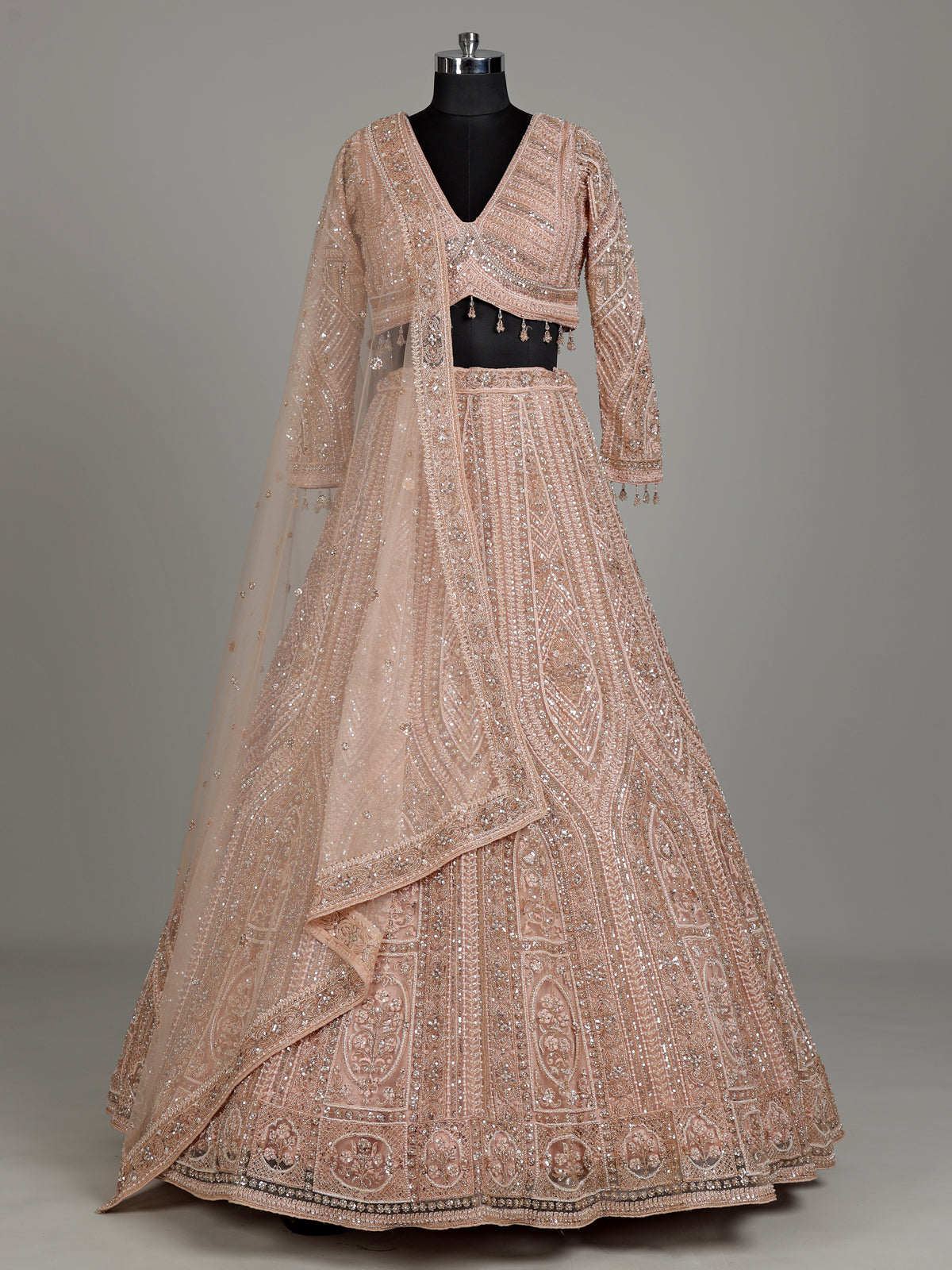 Peach net designer lehenga choli with intricate embellished dupatta