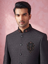 Jet black textured jodhpuri suit for mens with crest motif