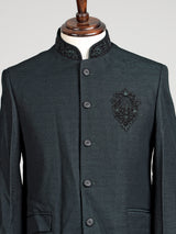 Deep emerald green textured jodhpuri suit for mens with crest
