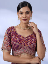Purple silk lehenga choli with chevron panels and embellished drape