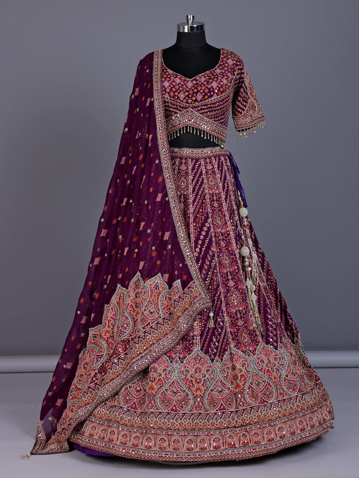 Purple silk lehenga choli with chevron panels and embellished drape