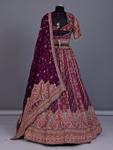Purple silk lehenga choli with chevron panels and embellished drape