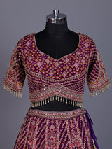 Purple silk lehenga choli with chevron panels and embellished drape