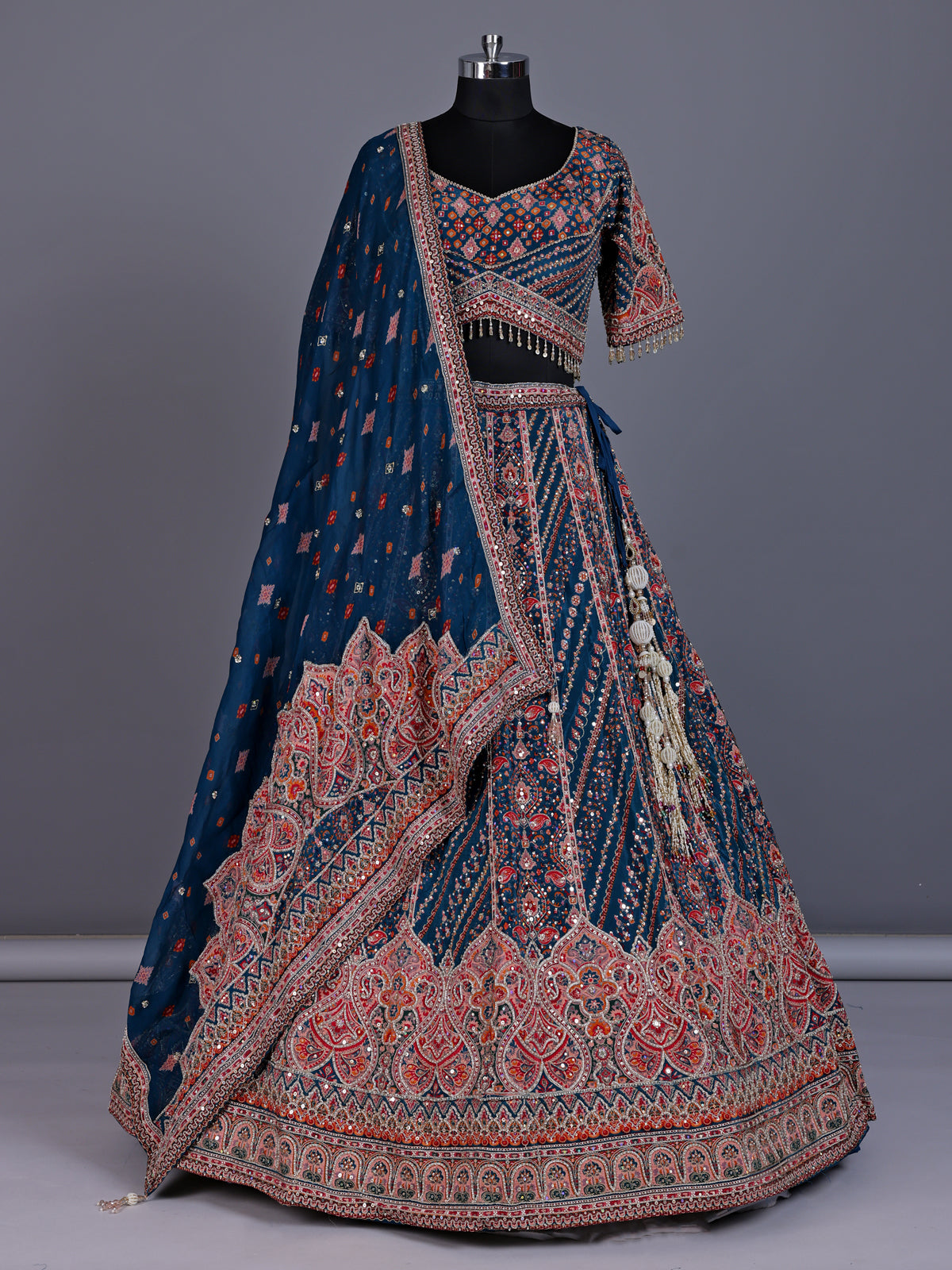Rama blue silk lehenga choli with chevron panels and embellishments