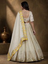 Beige silk lehenga choli with traditional aabla and gota work