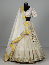 Beige silk lehenga choli with traditional aabla and gota work