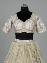Beige silk lehenga choli with traditional aabla and gota work