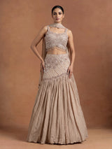 Beige chiffon silk lehenga choli with diamond and tassel detailing