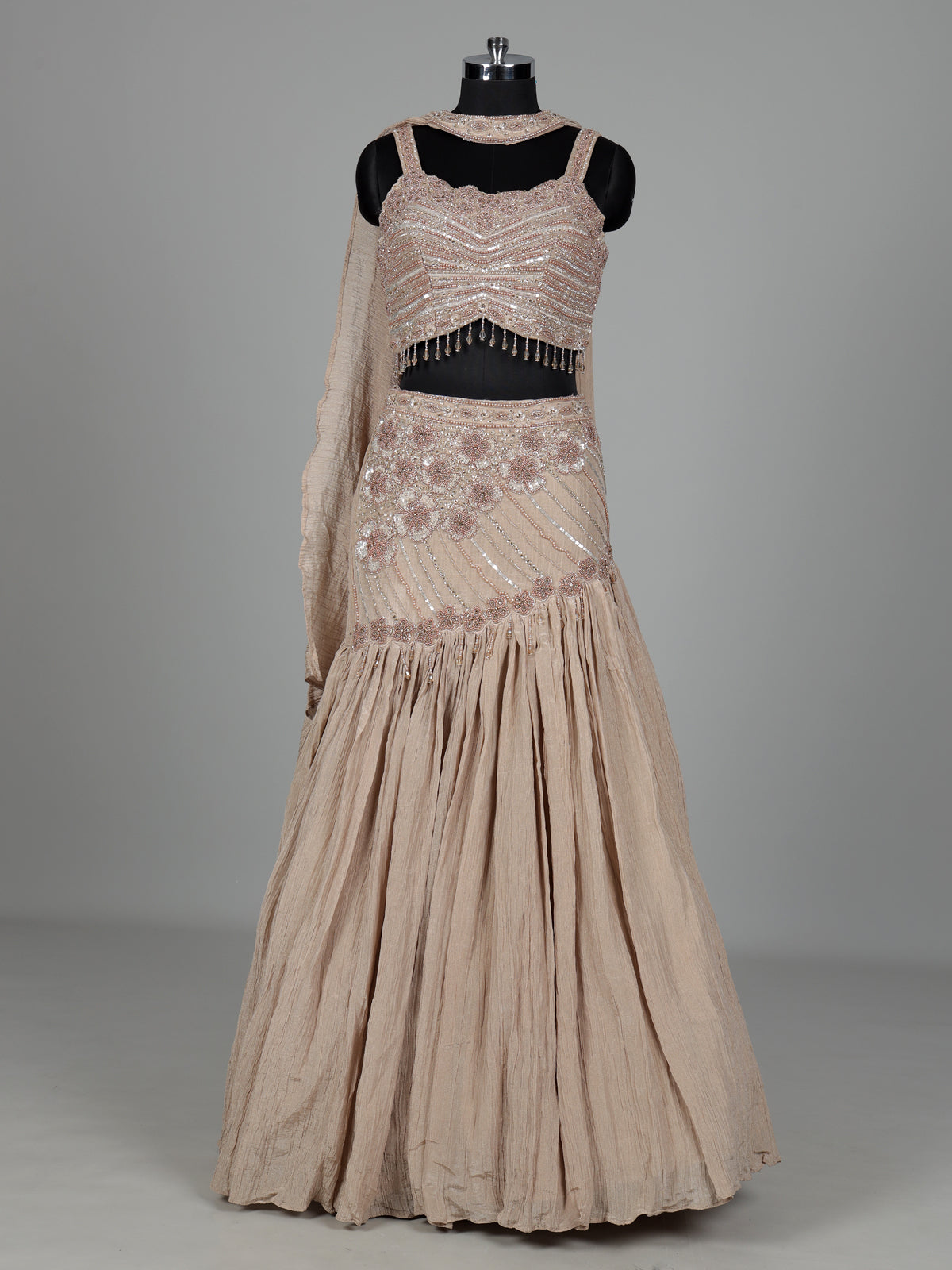 Beige chiffon silk lehenga choli with diamond and tassel detailing