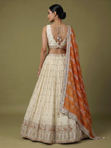 Beige silk lehenga choli with mirror work and contrast dupatta