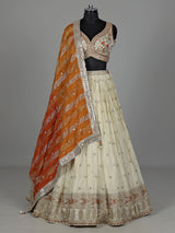 Beige silk lehenga choli with mirror work and contrast dupatta