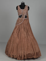 Beige chiffon silk lehenga choli with diamond and tassel accents