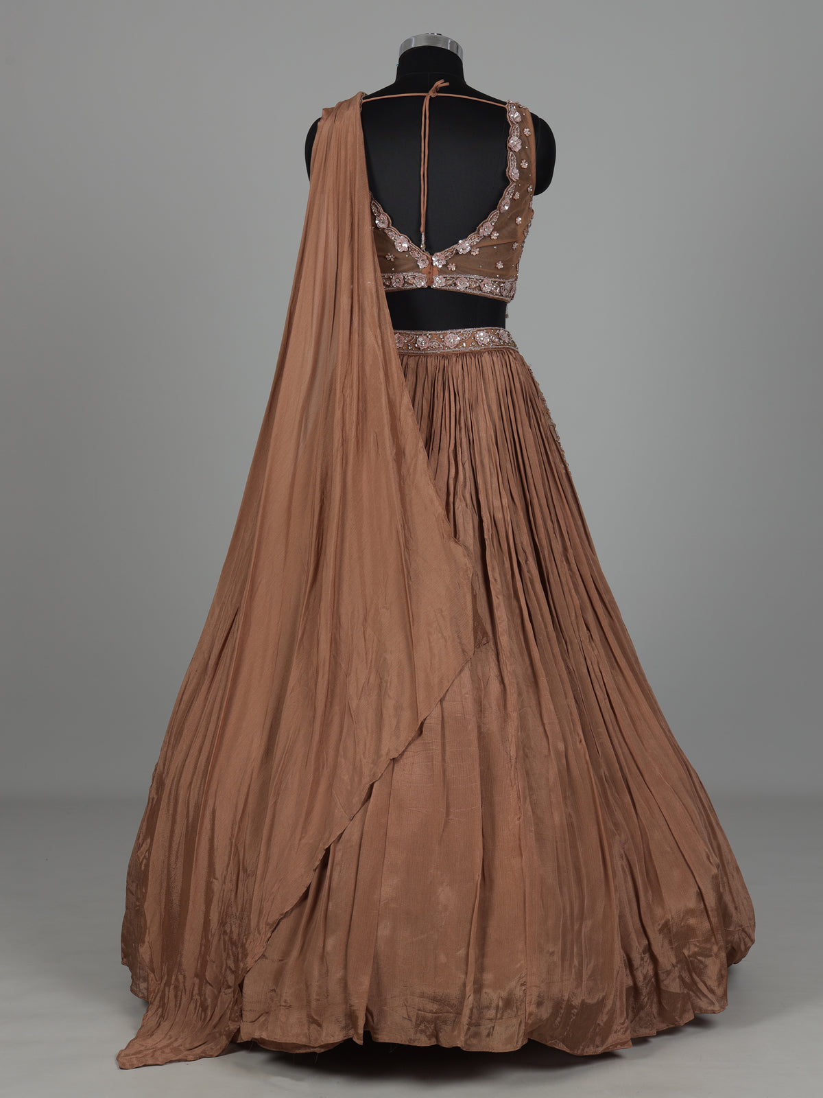 Beige chiffon silk lehenga choli with diamond and tassel accents