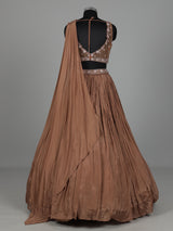 Beige chiffon silk lehenga choli with diamond and tassel accents