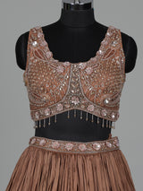 Beige chiffon silk lehenga choli with diamond and tassel accents