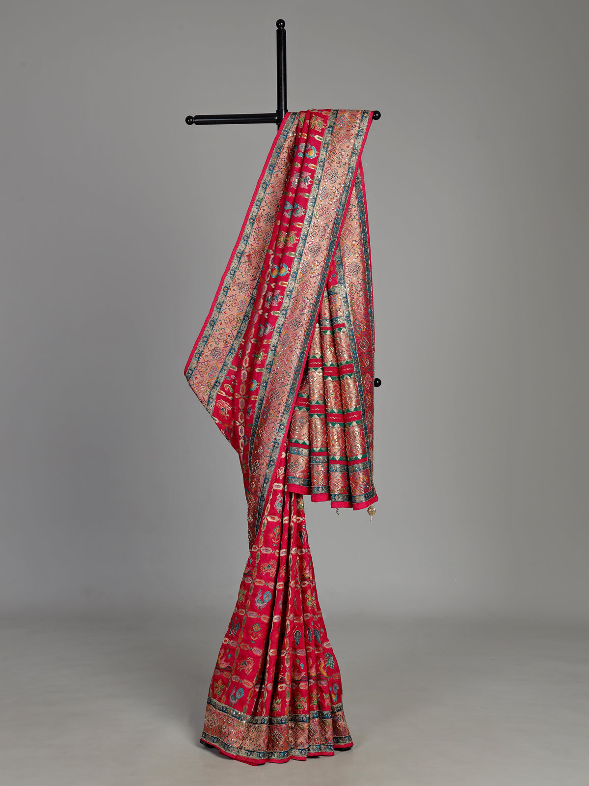 Deep rani pink modal satin saree with colourful motifs and embellishments