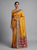 Mustard yellow modal satin saree with colourful motifs and tassel detailing