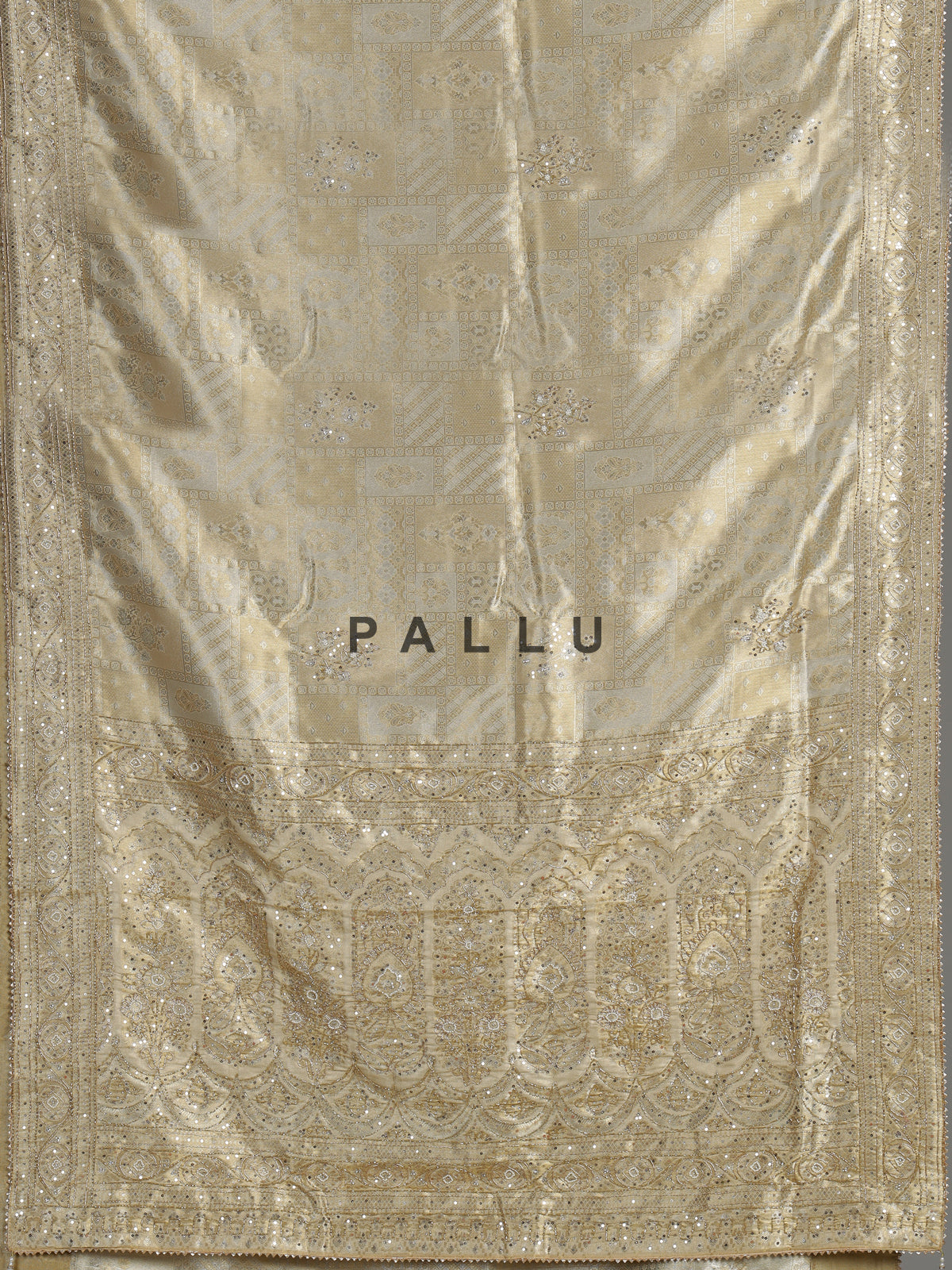 Pastel cream tissue silk saree with intricate festive embellishments and zari