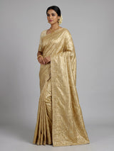 Cream tissue silk saree with mirror accents and intricate festive embroidery