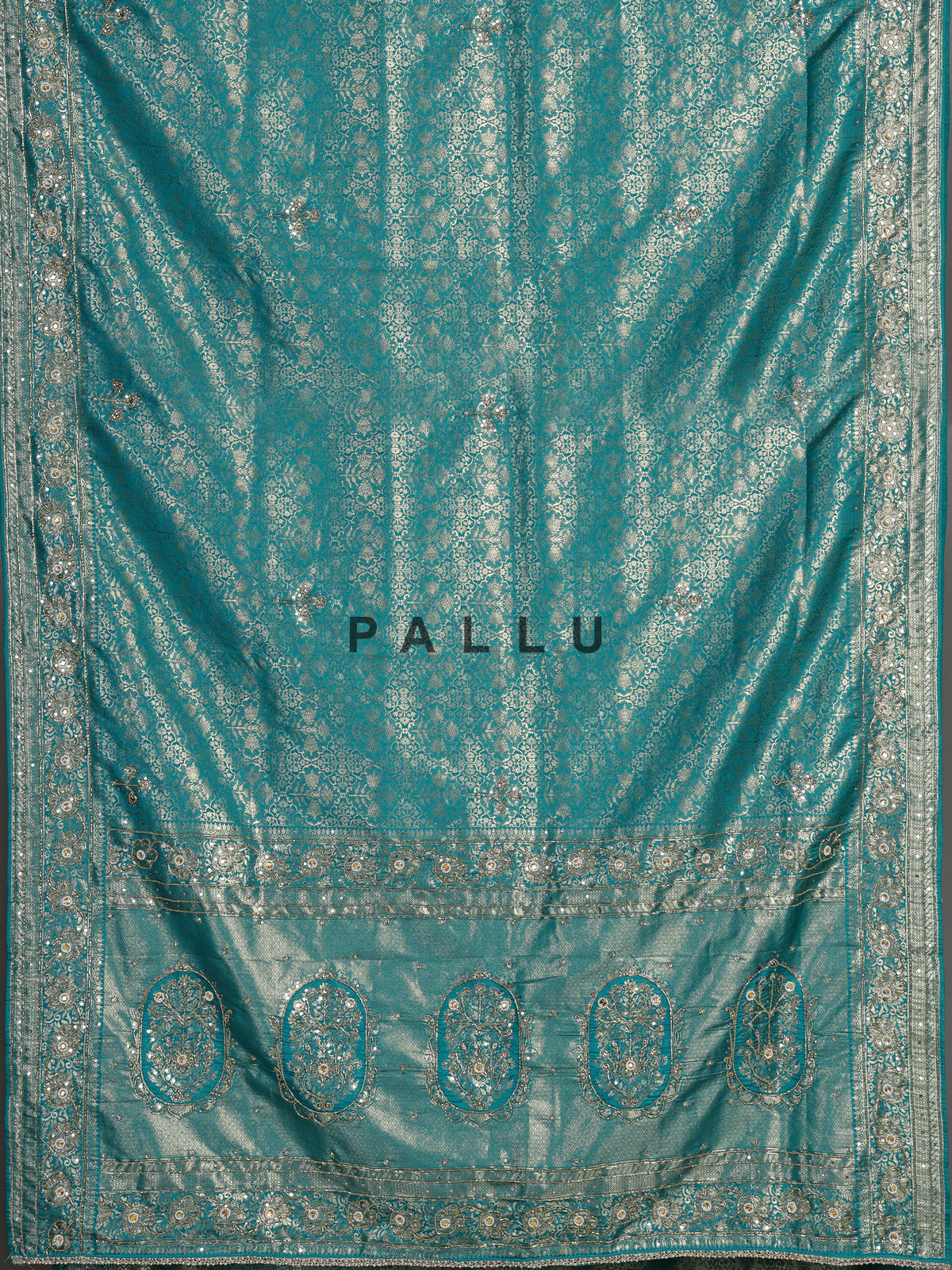 Aqua kanjivaram silk saree with ornate mirror work and zari accents
