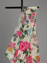 Cream crepe silk saree with checked patterns and floral embellishments