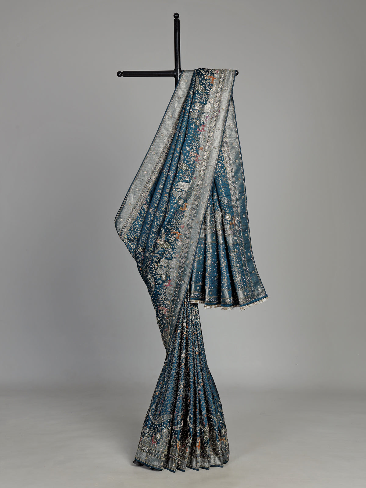 Teal blue semi silk saree with artistic animal and bird motifs