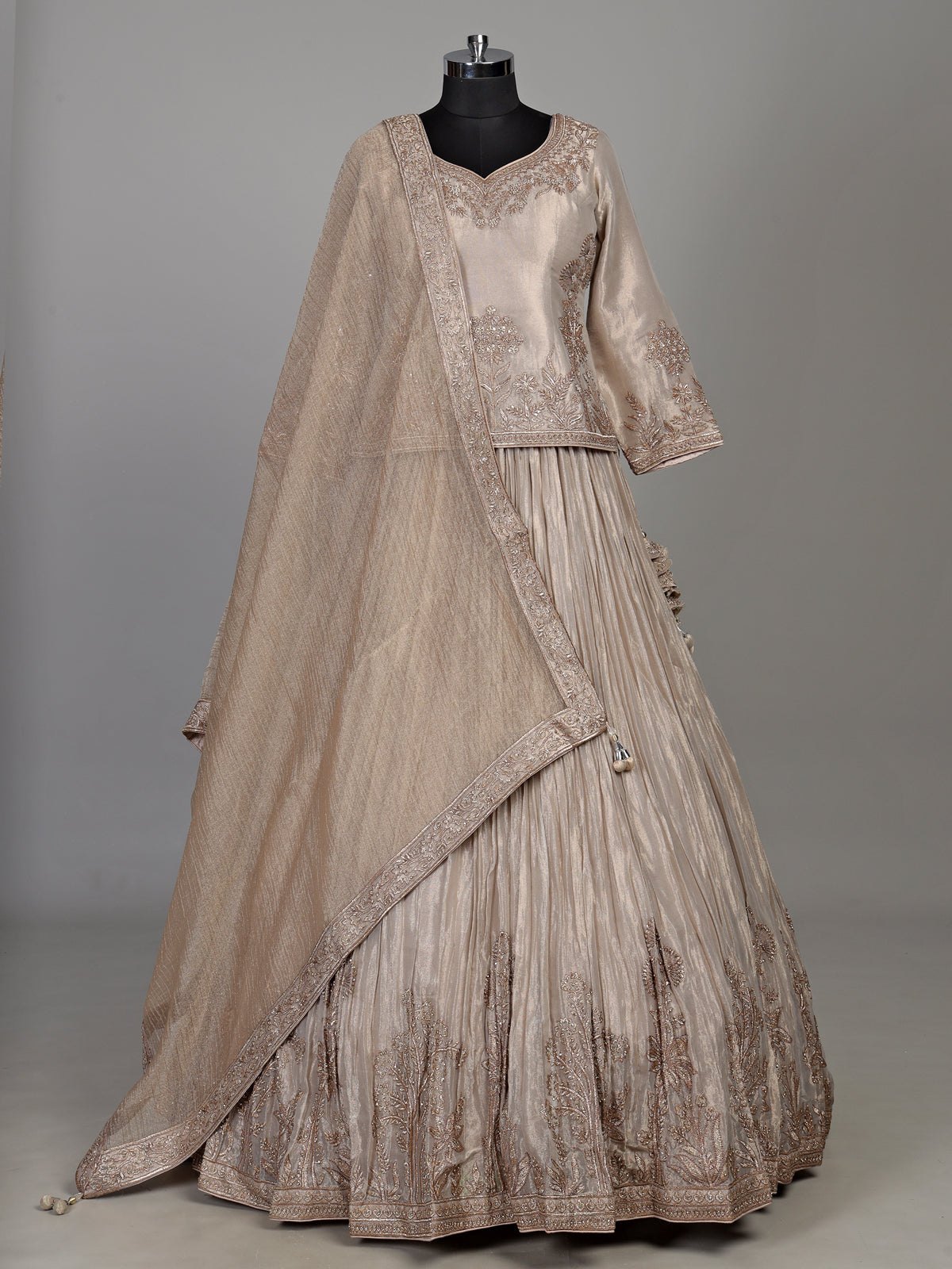 Pastel beige tissue silk lehenga choli with intricate zardosi detailing