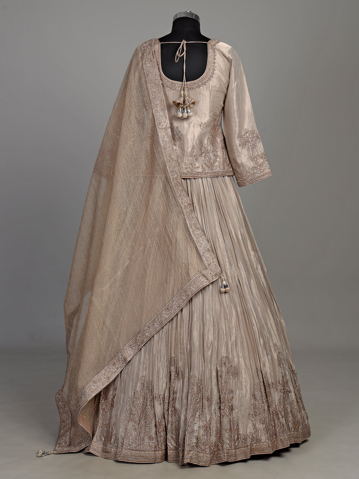 Pastel beige tissue silk lehenga choli with intricate zardosi detailing