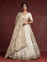 Cream banarasi silk lehenga choli with intricate zardosi embellishments