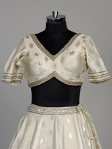 Cream banarasi silk lehenga choli with intricate zardosi embellishments